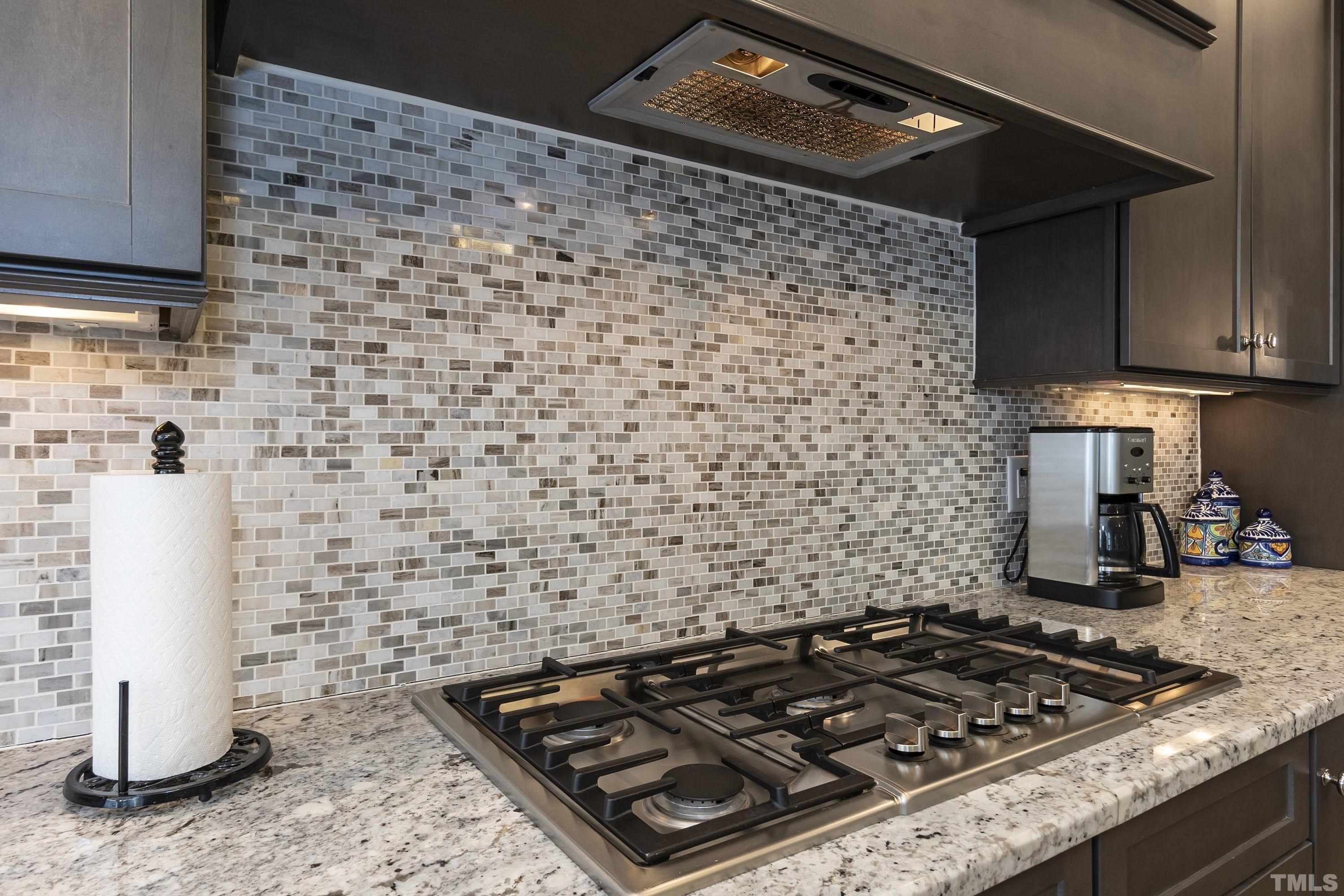 6418 Rosny Road Raleigh, NC 27613 - Photo 18 of 52 a stove top oven sitting inside of a kitchen