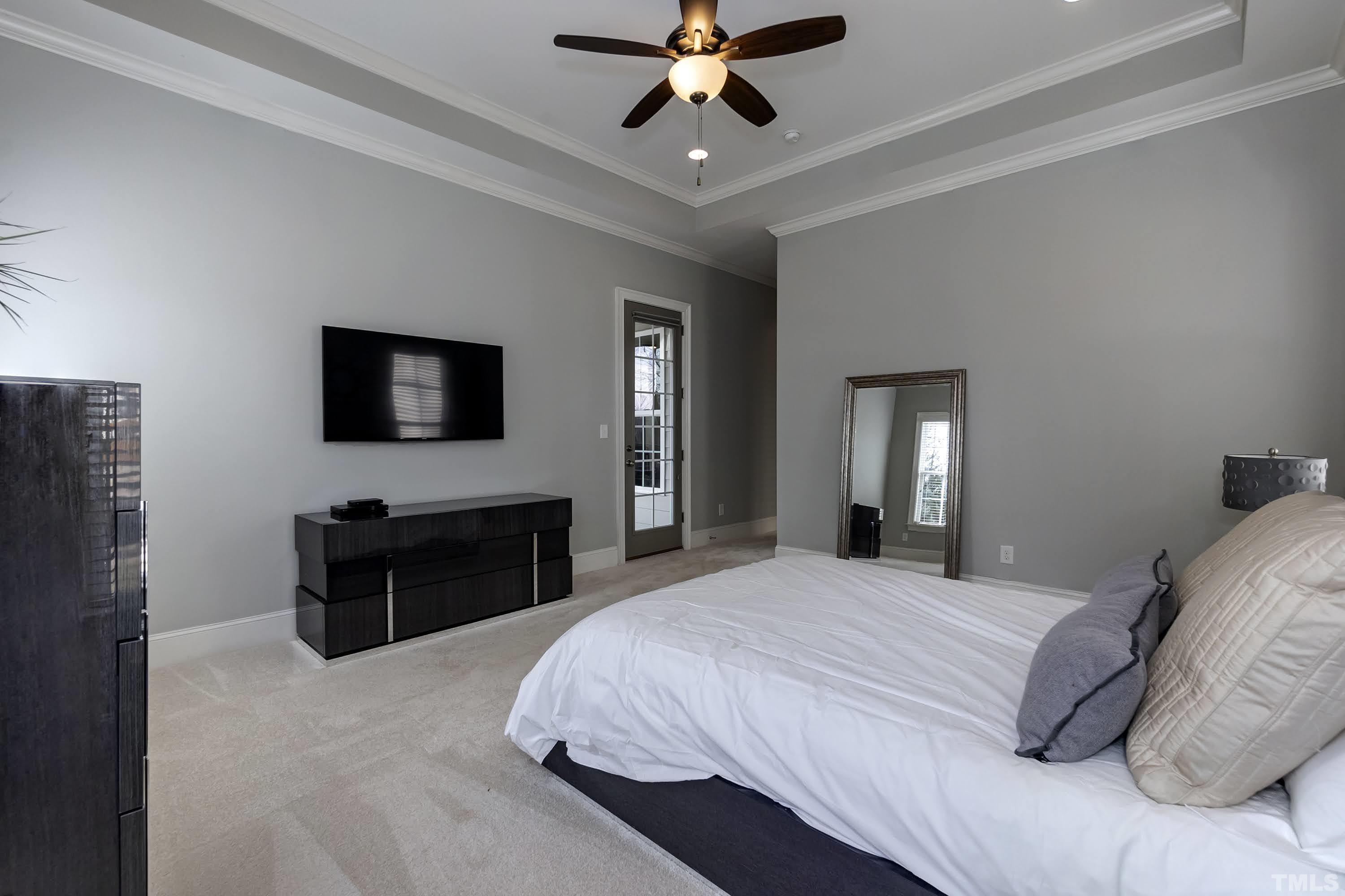6418 Rosny Road Raleigh, NC 27613 - Photo 29 of 52 a bedroom with a bed and a flat screen television