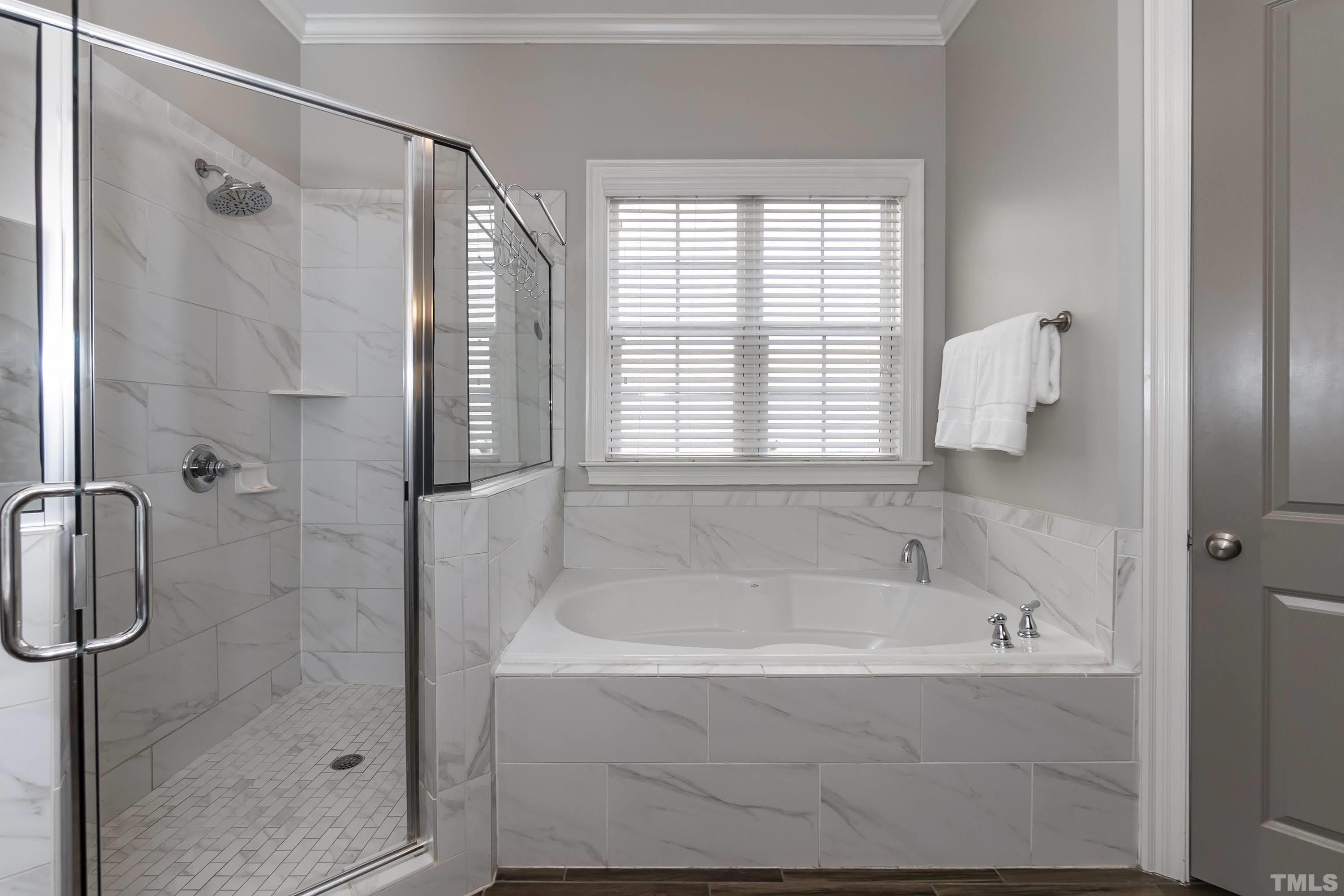 6418 Rosny Road Raleigh, NC 27613 - Photo 31 of 52 a white bath tub sitting next to a shower