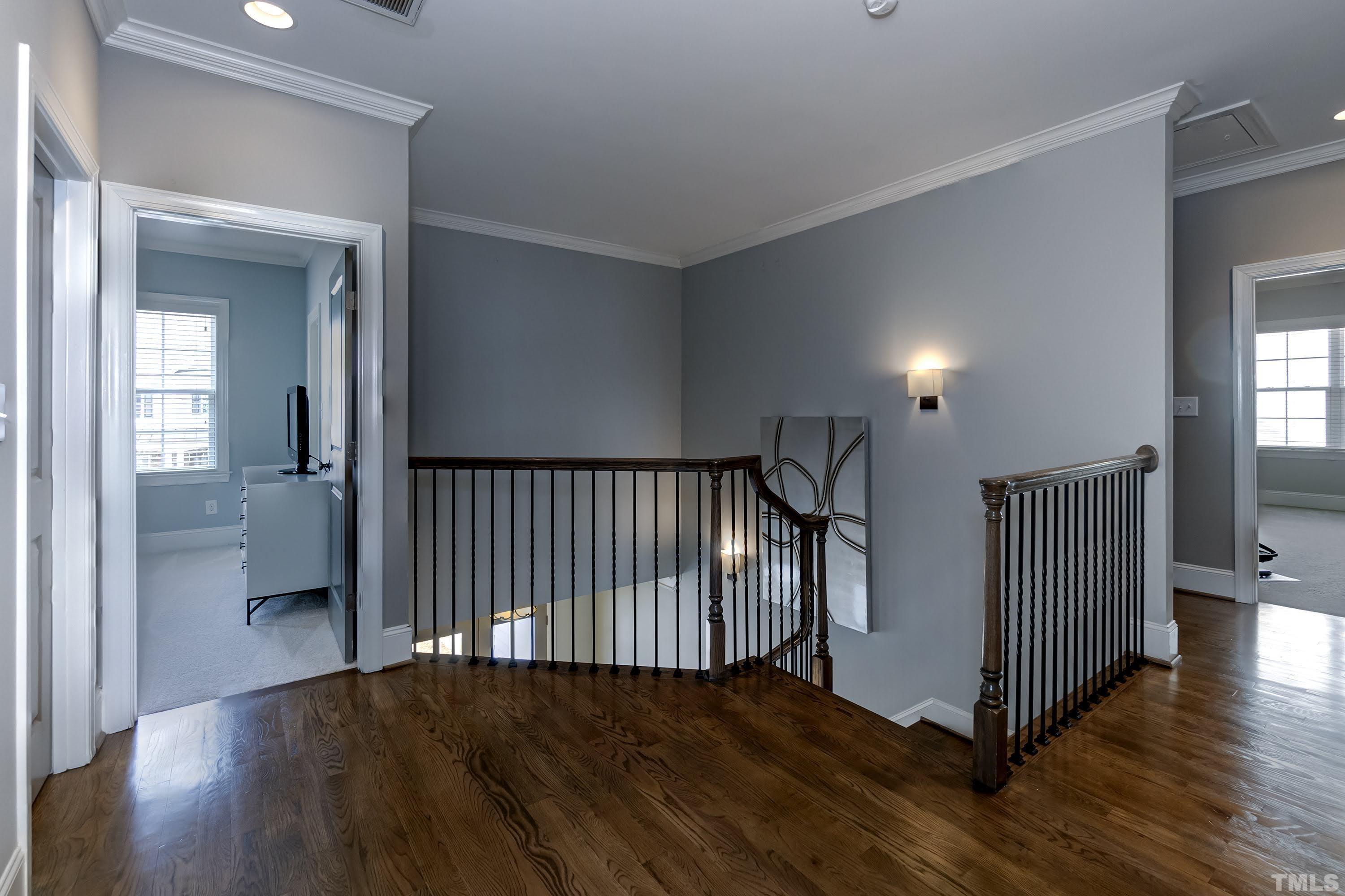 6418 Rosny Road Raleigh, NC 27613 - Photo 33 of 52 a view of a hallway view with wooden floor and staircase