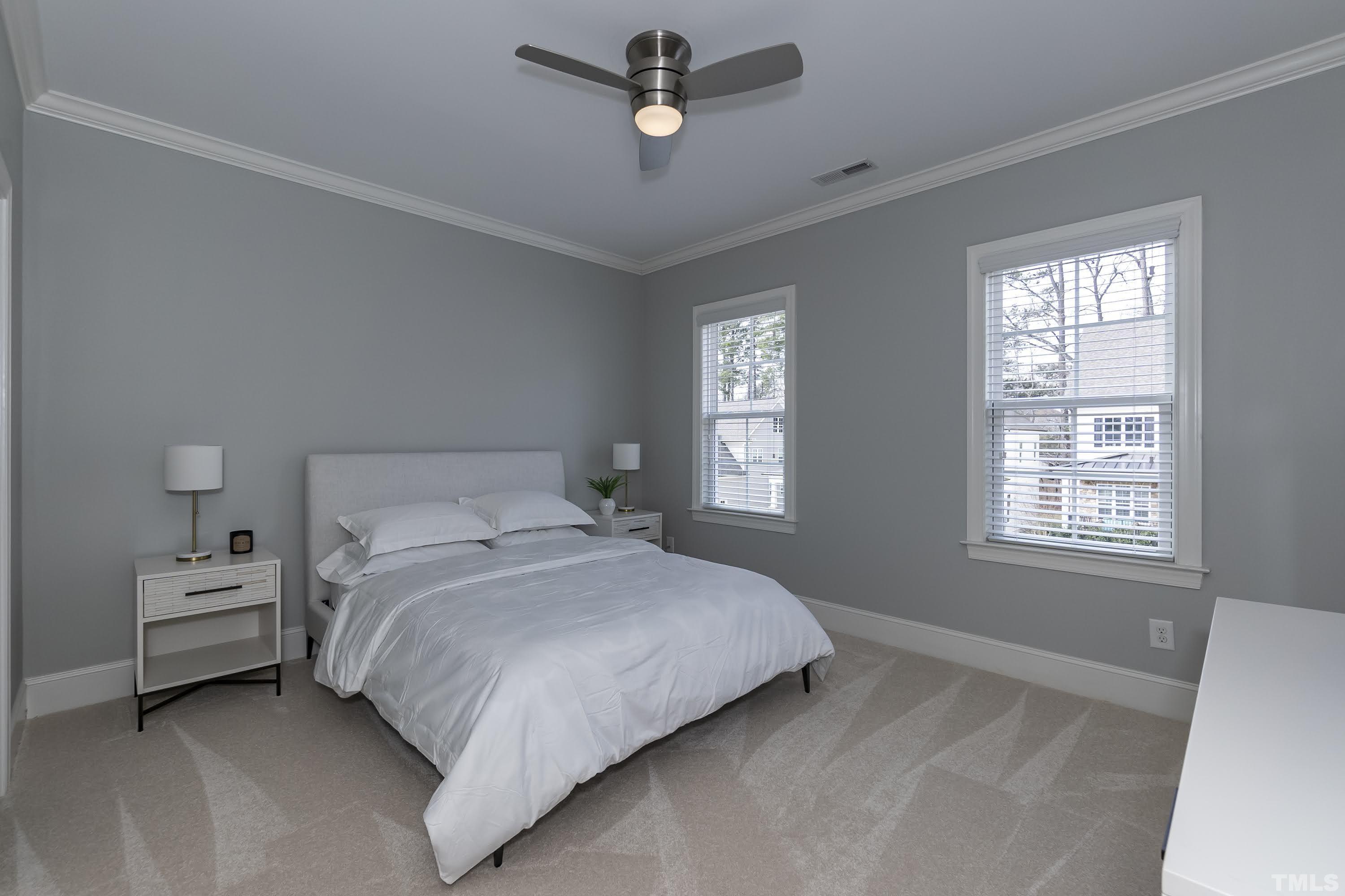 6418 Rosny Road Raleigh, NC 27613 - Photo 34 of 52 a bedroom with a bed a window and a couch