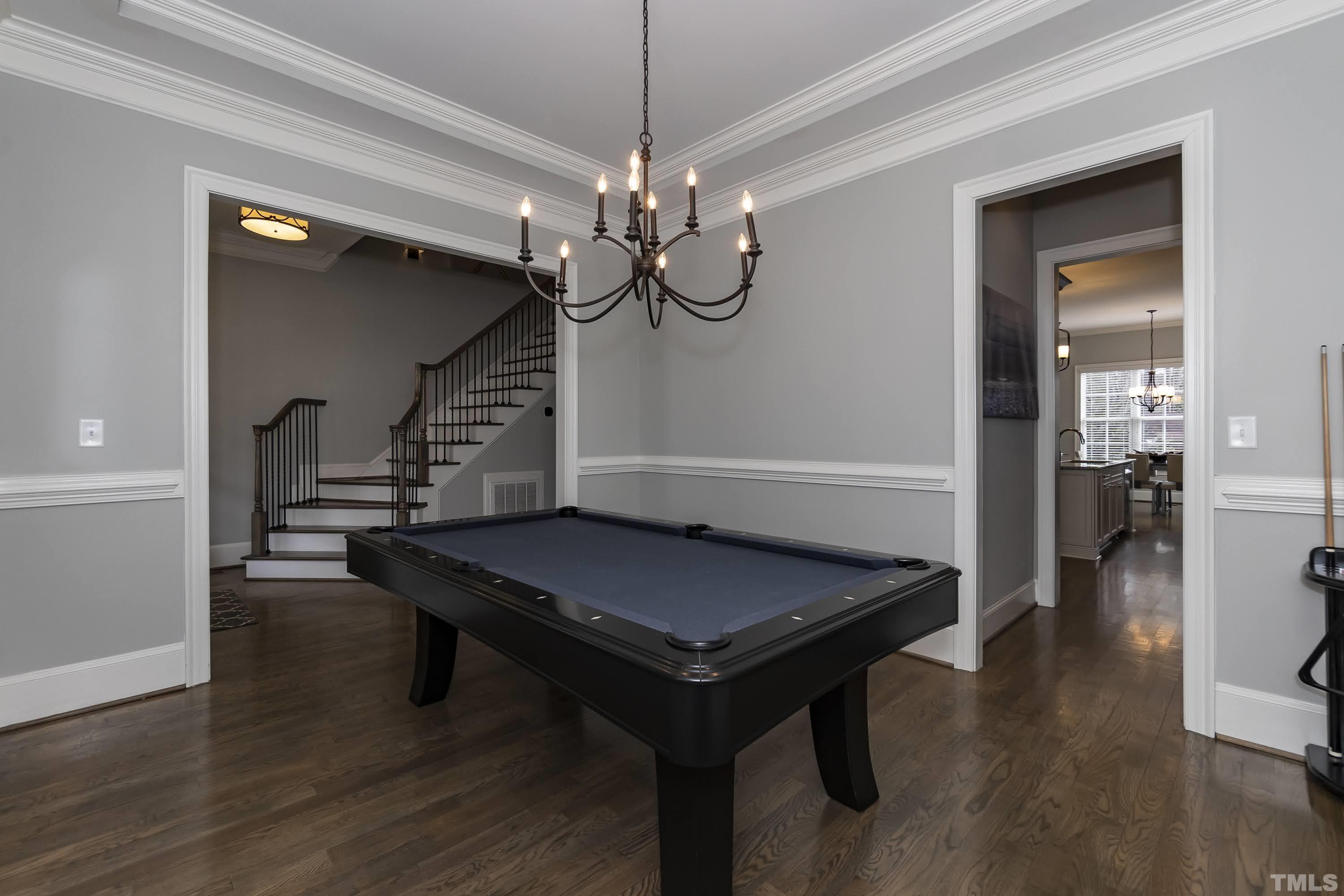 6418 Rosny Road Raleigh, NC 27613 - Photo 7 of 52 a room with wooden floor pool table and windows