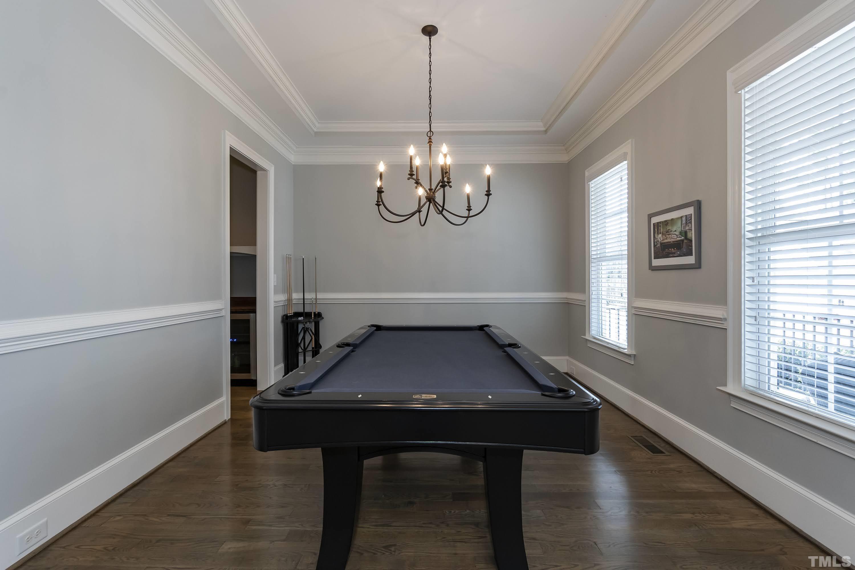 6418 Rosny Road Raleigh, NC 27613 - Photo 9 of 52 a room with chandelier and wooden floor