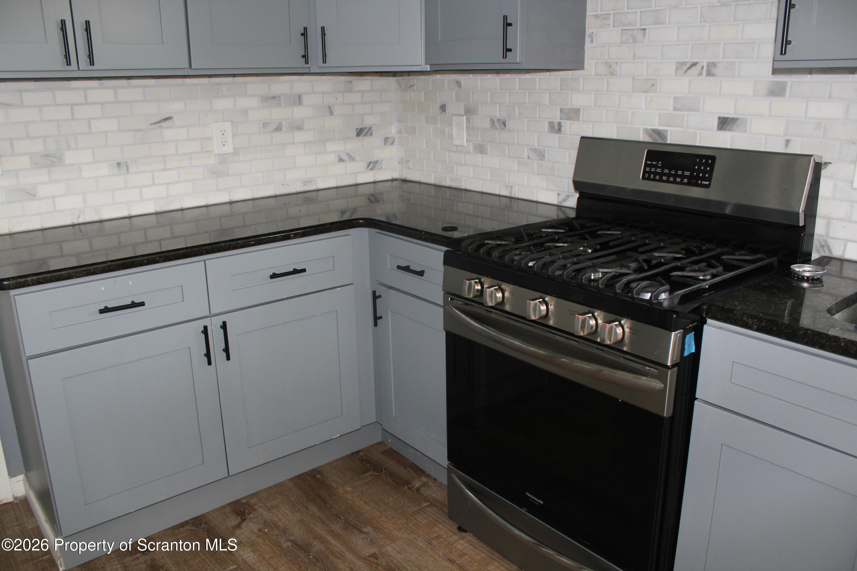 1122 Luzerne Street, Unit A Scranton, PA 18504 - Photo 4 of 13 a stove top oven sitting inside of a kitchen
