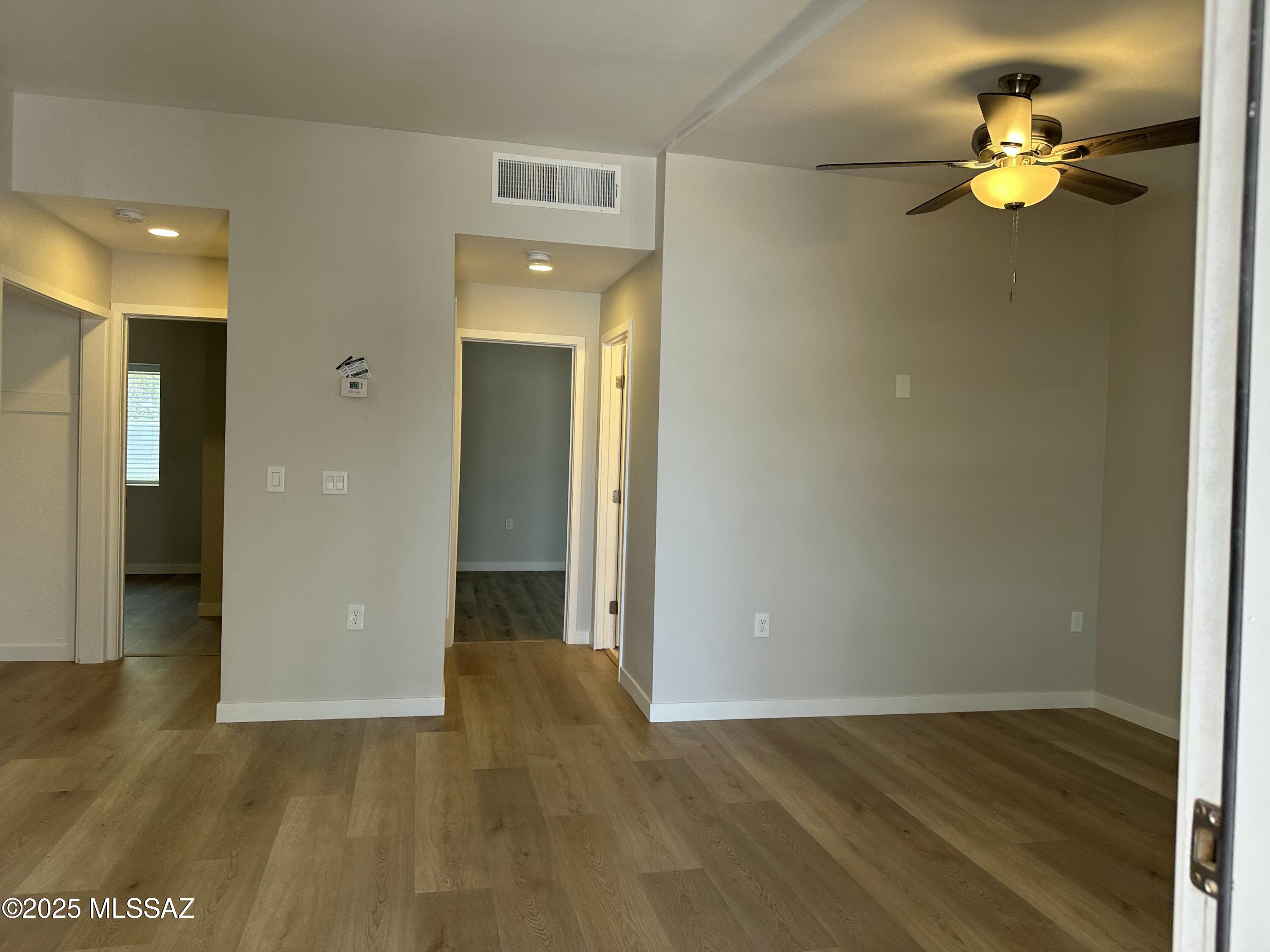 645 East Mabel Street Tucson, AZ 85705 - Photo 8 of 22 a view of an empty room with wooden floor