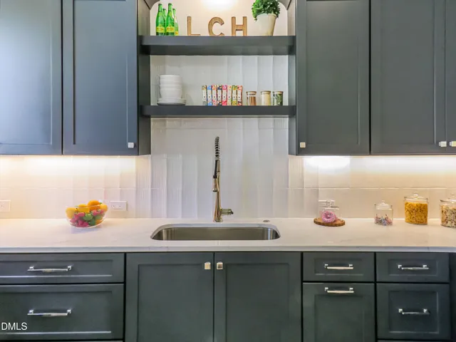 a view of a livingroom with wooden floor and a fireplace