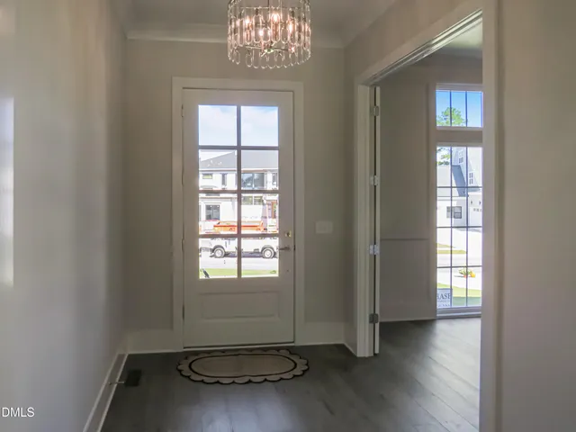 a view of an empty room with a fireplace and a window