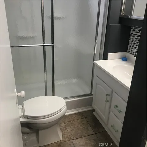 a bathroom with a toilet a sink and a shower
