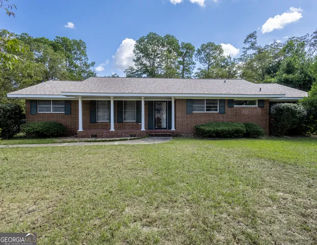 a front view of house with yard and green space