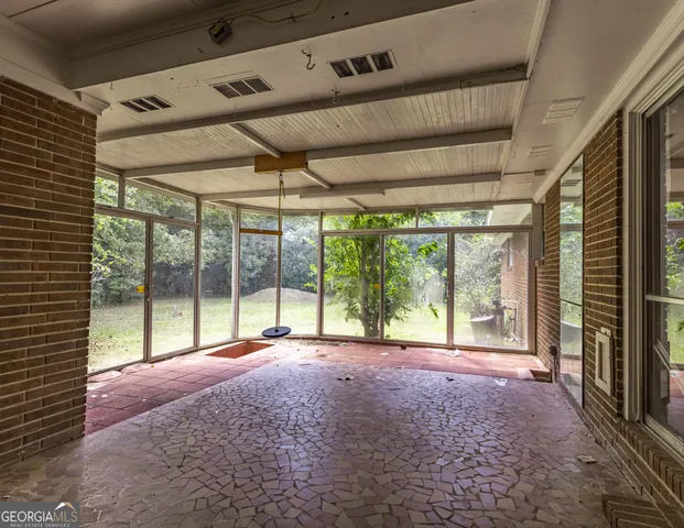 a view of an empty room with windows and a balcony