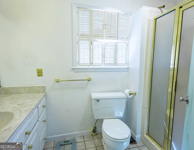 a white toilet sitting next to a window