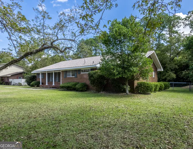 a front view of a house with a garden