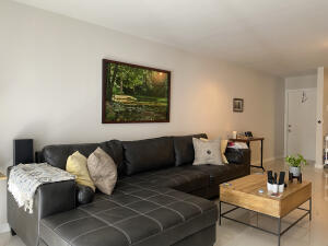 2650 Greenwood Terrace, Unit 1250 Boca Raton, FL 33431 - Photo 8 of 25 a living room with furniture rug and lamp