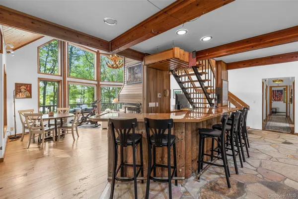 a dining room with furniture window and wooden floor