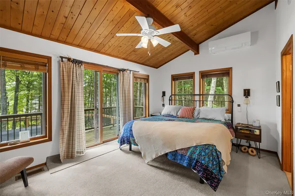 a bedroom with a large bed and a balcony view