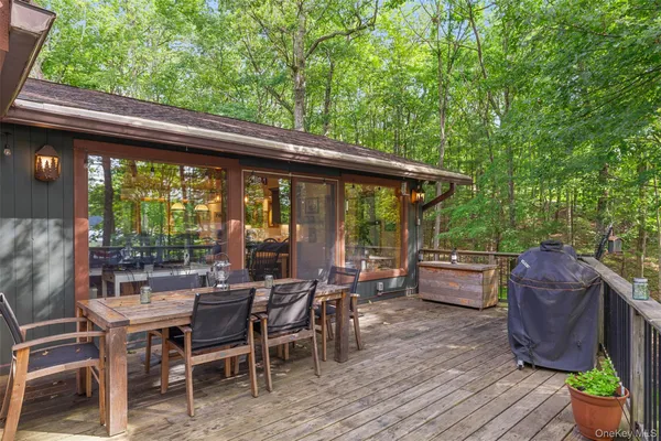 a view of roof deck with lawn chairs and wooden fence