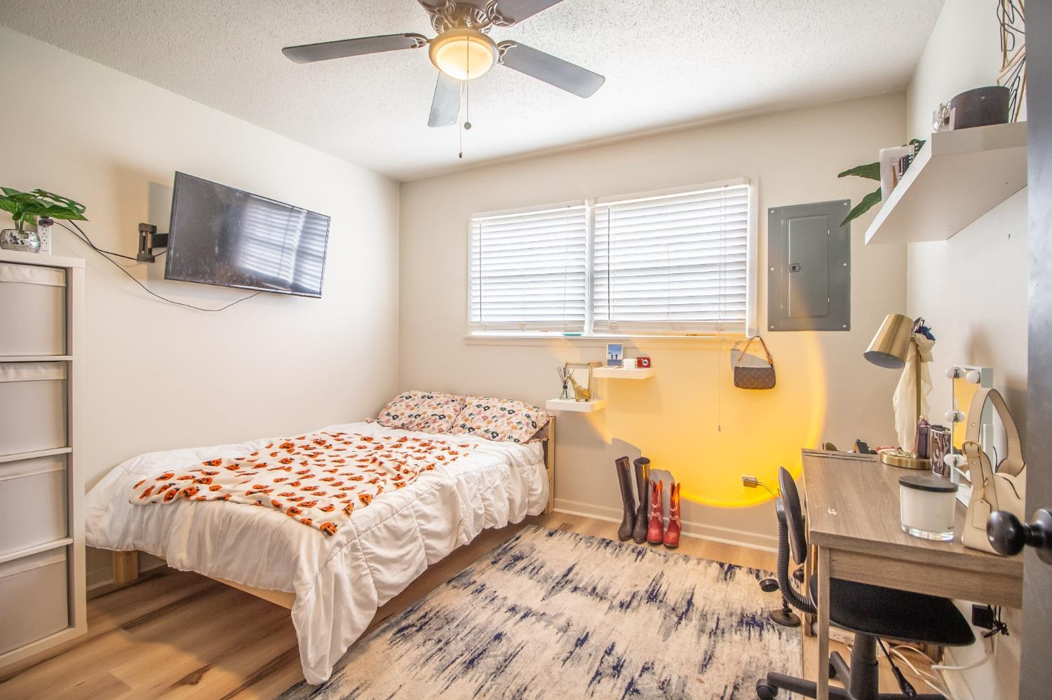 5411 32nd Street Lubbock, TX 79407 - Photo 15 of 22 a bedroom with a bed and a table with the dresser