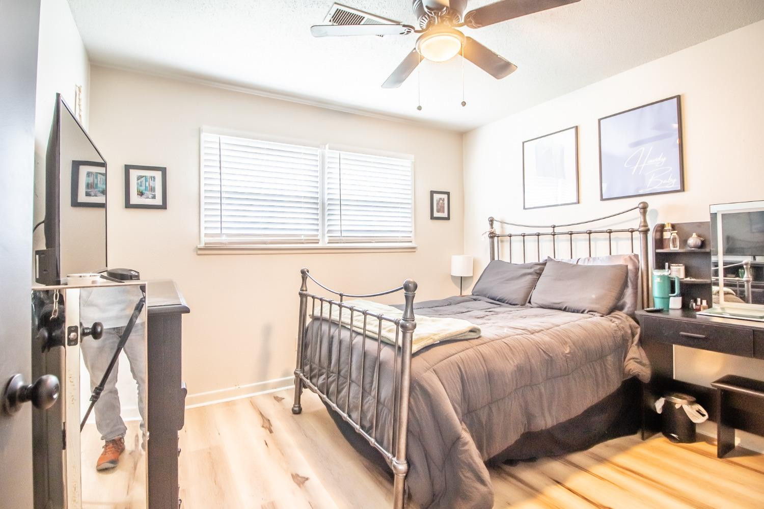 5411 32nd Street Lubbock, TX 79407 - Photo 17 of 22 a bedroom with a bed and a chandelier
