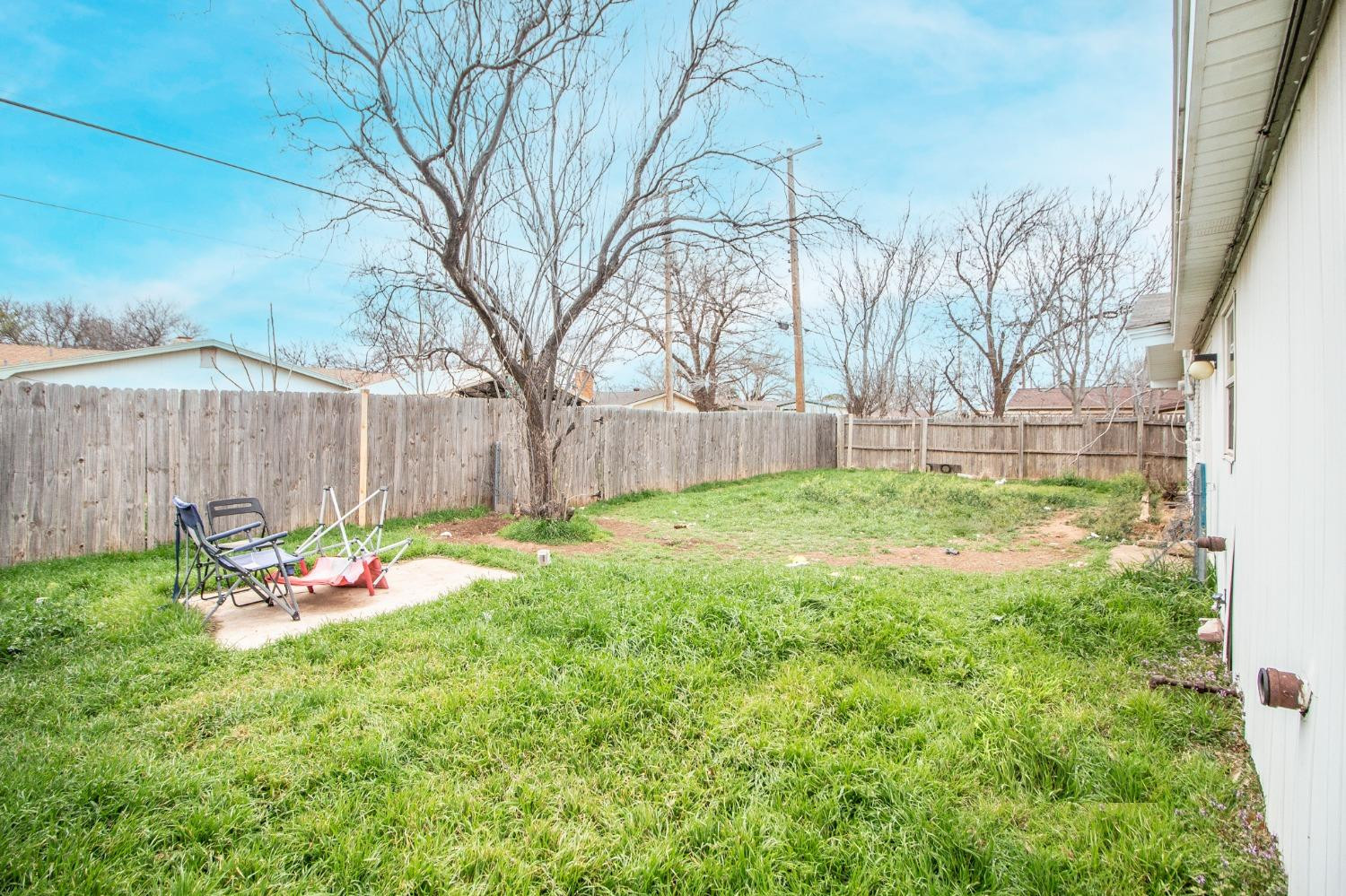 5411 32nd Street Lubbock, TX 79407 - Photo 21 of 22 a backyard of a house with table and chairs