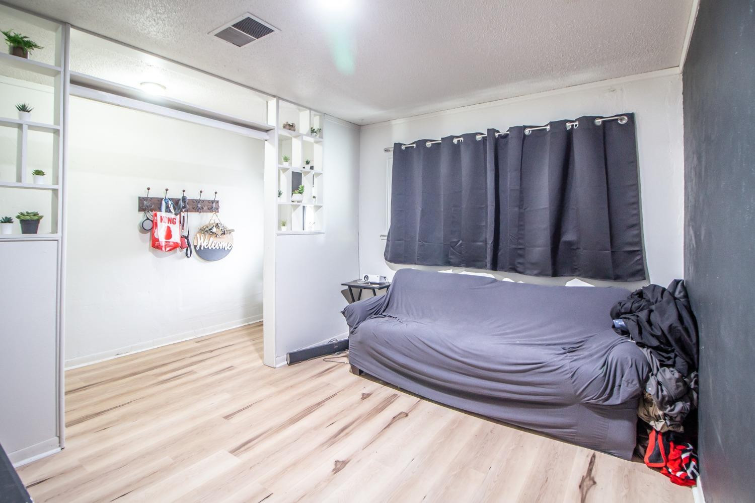 5411 32nd Street Lubbock, TX 79407 - Photo 4 of 22 a bedroom with a bed and a walk in closet