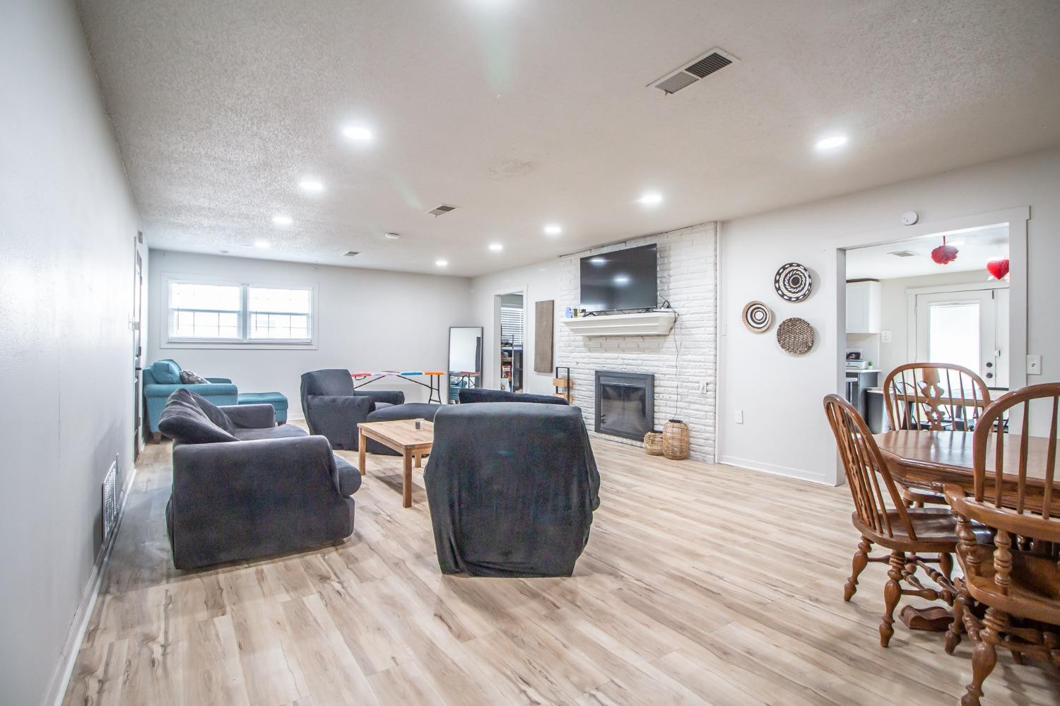 5411 32nd Street Lubbock, TX 79407 - Photo 5 of 22 a living room with furniture a table and a fireplace