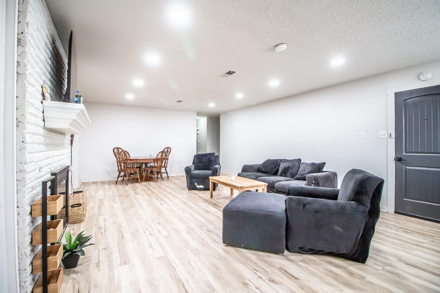 5411 32nd Street Lubbock, TX 79407 - Photo 6 of 22 a living room with furniture and a wooden floor
