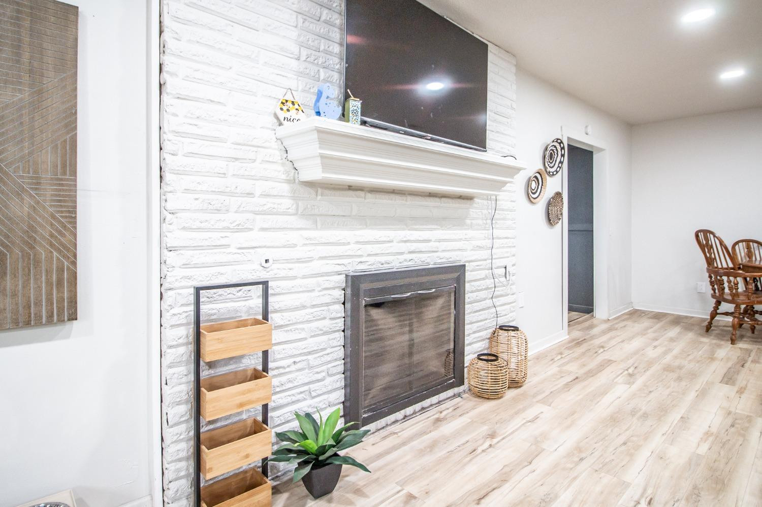 5411 32nd Street Lubbock, TX 79407 - Photo 7 of 22 a bedroom with a bed and a fireplace