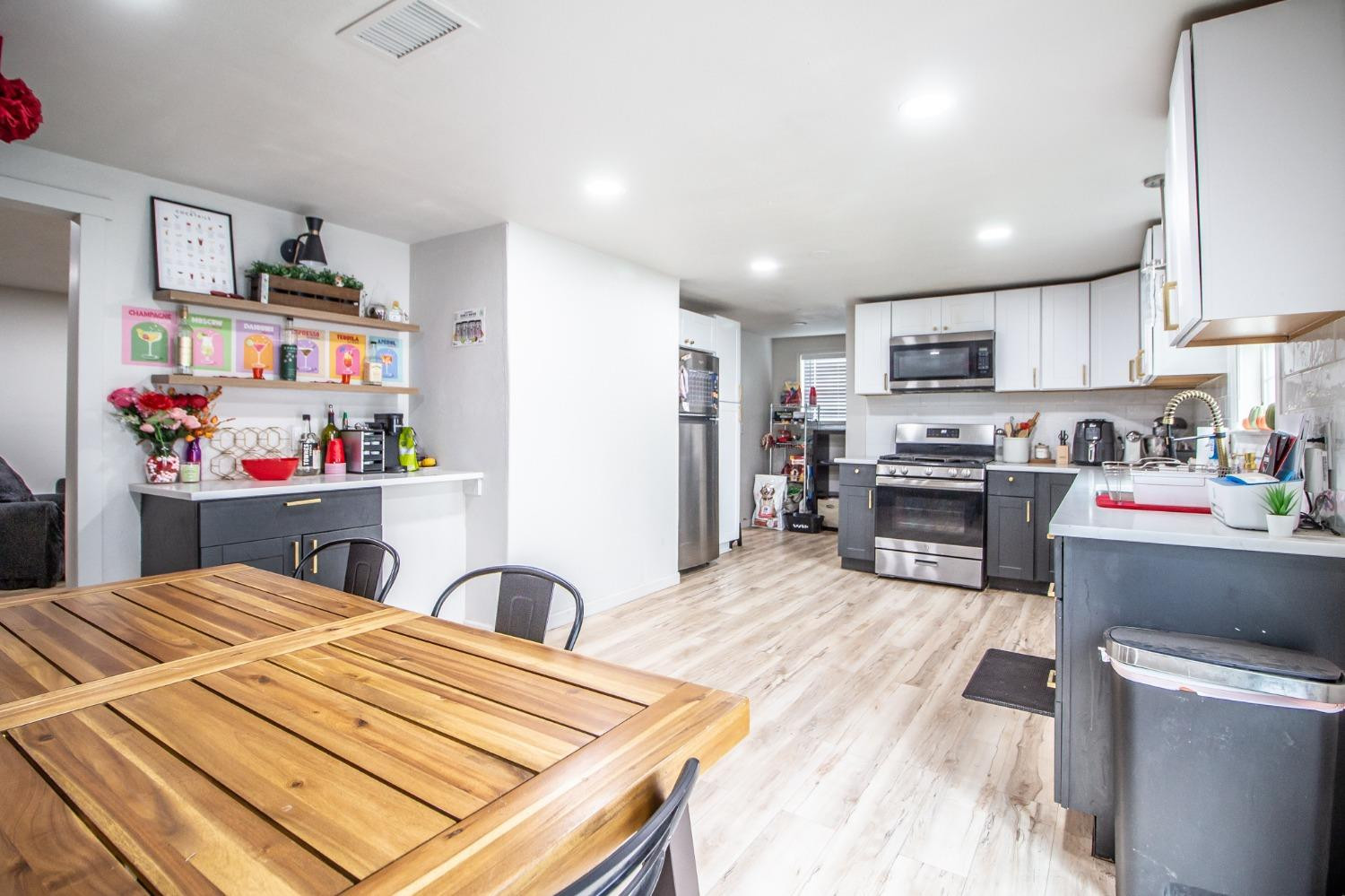 5411 32nd Street Lubbock, TX 79407 - Photo 8 of 22 a kitchen with stainless steel appliances kitchen island granite countertop a sink and a refrigerator