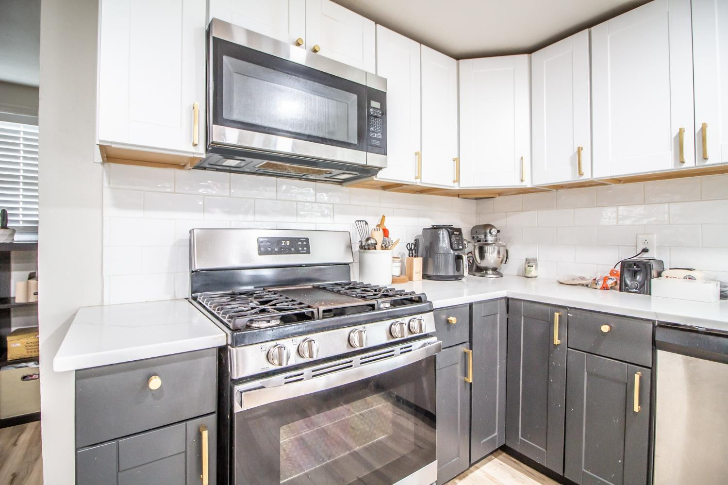 5411 32nd Street Lubbock, TX 79407 - Photo 9 of 22 a kitchen with cabinets and a stove top oven