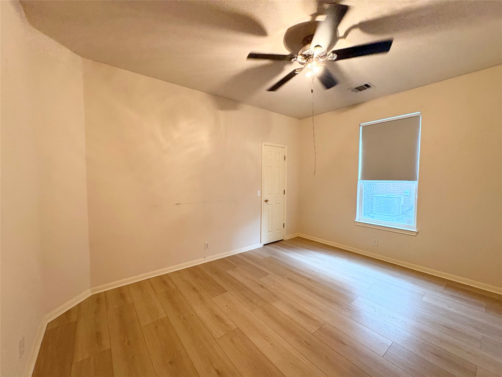 7006 Rambollet Terrace Round Rock, TX 78681 - Photo 23 of 38 Bright, neutral-toned walls complement the smooth plank flooring in this inviting living space.