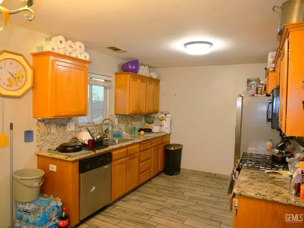 a kitchen with stainless steel appliances granite countertop a sink stove and cabinets