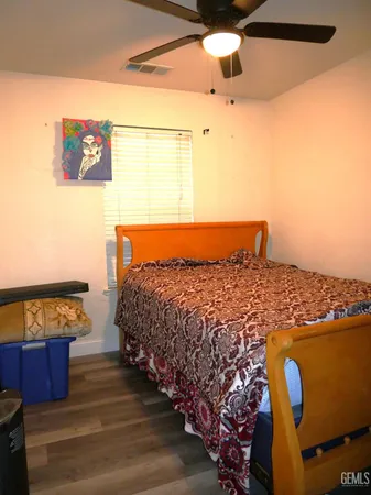 a bed sitting in a bedroom next to a window