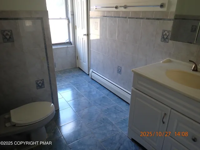 a bathroom with a toilet and a sink