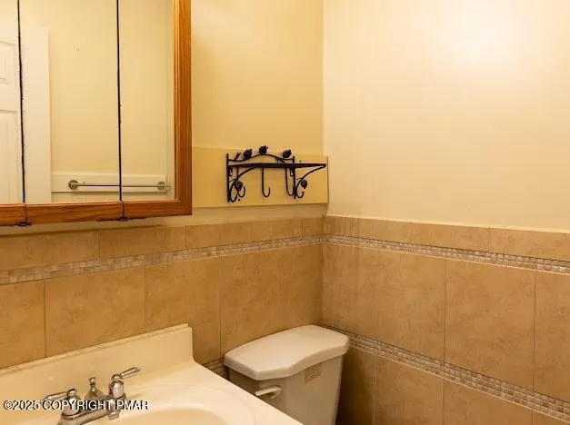 a bathroom with a toilet sink and vanity