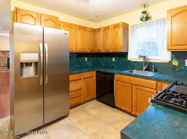 a kitchen with stainless steel appliances granite countertop a refrigerator and a sink