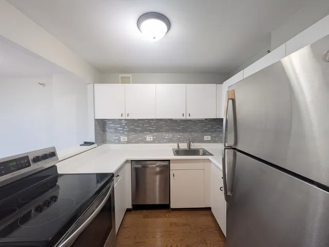 a kitchen that has a sink and a stove