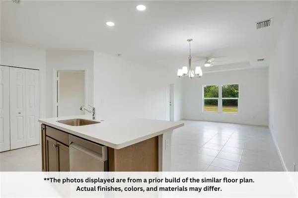a open kitchen with a sink and a window