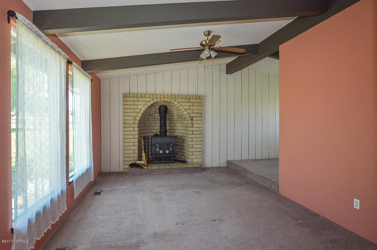 10820 Mieras Road Yakima, WA 98901 - Photo 19 of 21 a view of empty room with fireplace and windows