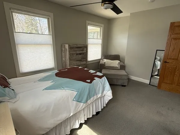 a bedroom with bed and a window