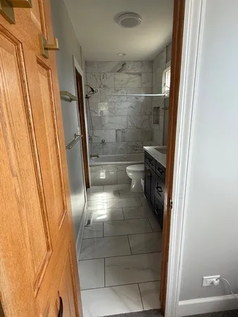 a bathroom with a glass door shower
