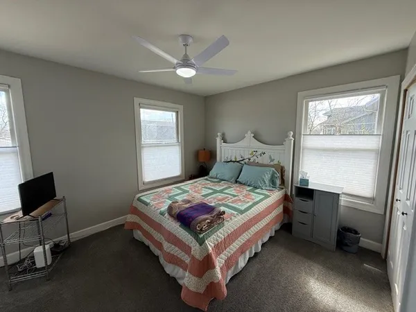 a bedroom with a bed and window