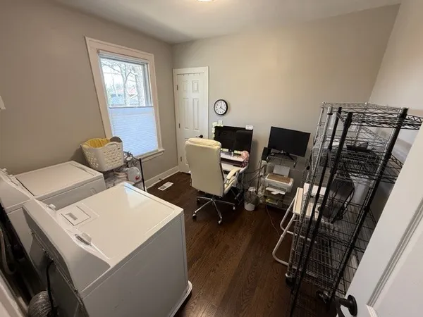 a bathroom with a sink a toilet a mirror and a window