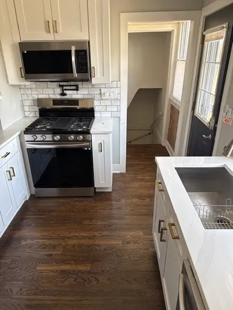a kitchen with a stove and a microwave