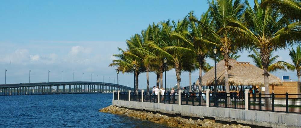 25188 Marion Avenue, Unit C302 Punta Gorda, FL 33950 - Photo 18 of 19 a view of swimming pool with outdoor seating and plants