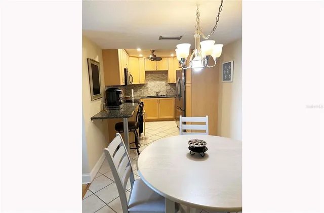 a bathroom with a sink a mirror and potted plant