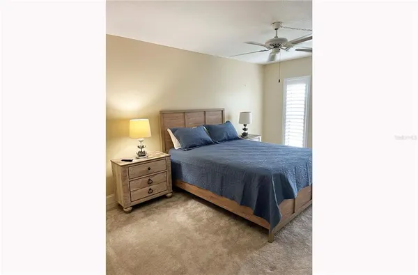 a spacious bedroom with a bed and a chandelier