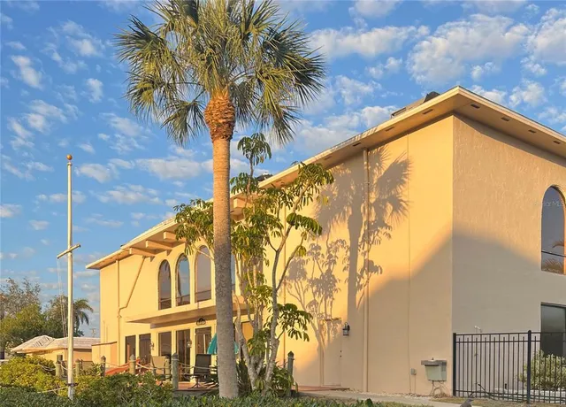 a view of a house with a palm tree
