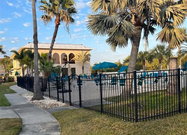 a view of a palm trees front of house with swimming pool
