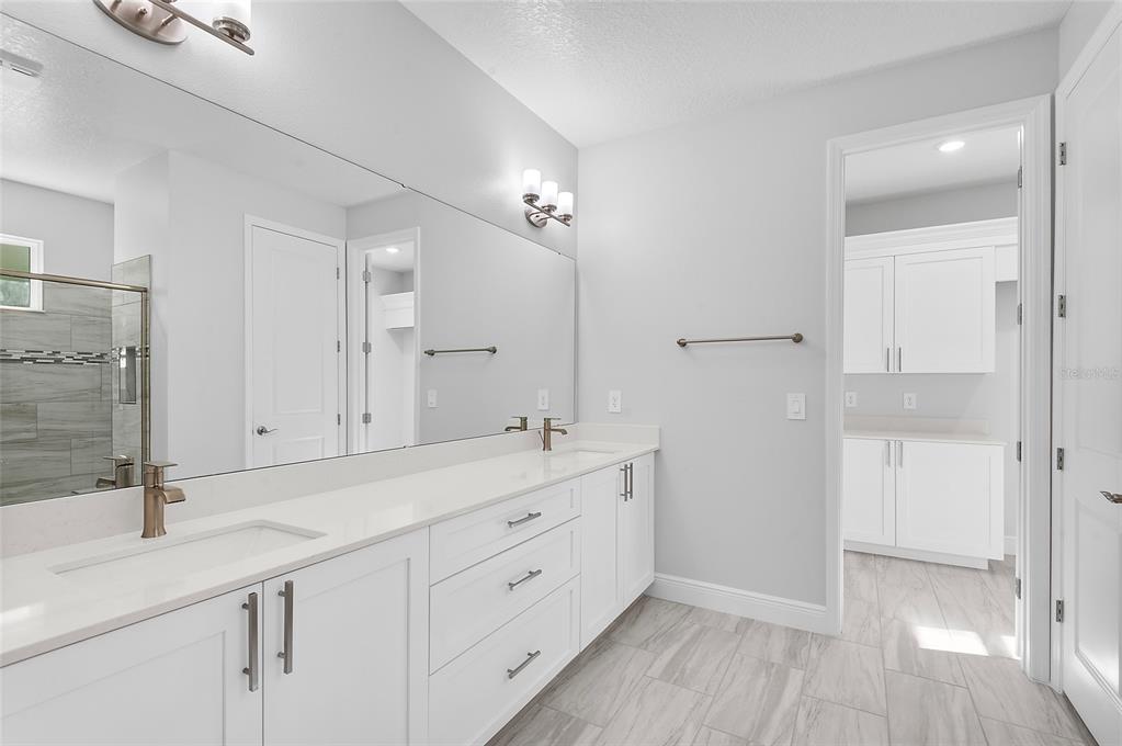 304 North Jungle Road Geneva, FL 32732 - Photo 26 of 49 a spacious bathroom with a shower sink and mirror