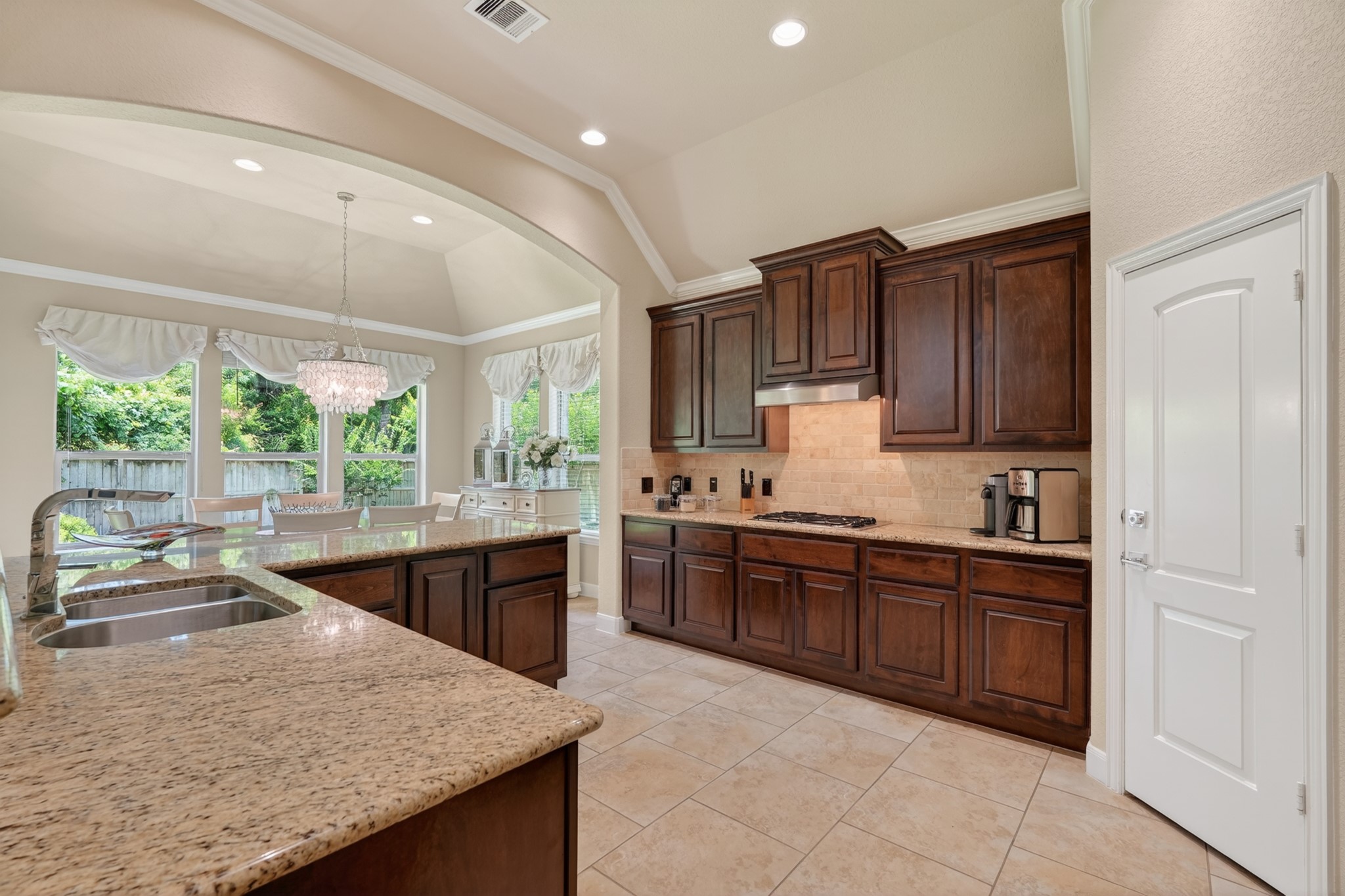 55 South Victoriana Circle Spring, TX 77389 - Photo 16 of 40 a kitchen with stainless steel appliances granite countertop wooden cabinets a stove top oven a sink and dishwasher